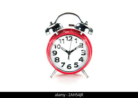 Vintage table clock with bell, red color, isolated on white bacground. Stock Photo