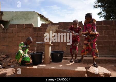 Group Of African Girls Collecting Water At The Borehole Stock Photo