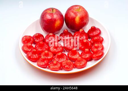 Dish of fresh rose apples and apples isolated on white background Stock Photo