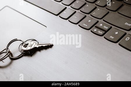 Close up of Still life of Key Ring on laptop computer keyboard. Conceptual image shown as network security key. Cyber Security, protection and privacy Stock Photo