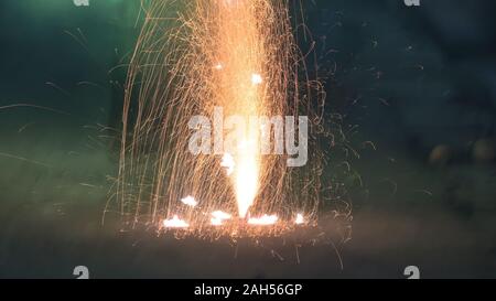 Bright and colorful fireworks showing display at night in City Street during Diwali festival celebration in Kolkata India. Close-up. Copy space room f Stock Photo