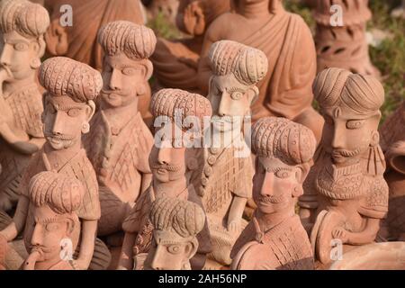 Male figurines made of red clay. Stock Photo