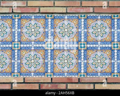 Closeup of decorative Tiles recessed in brick wall in Andalusian village Stock Photo