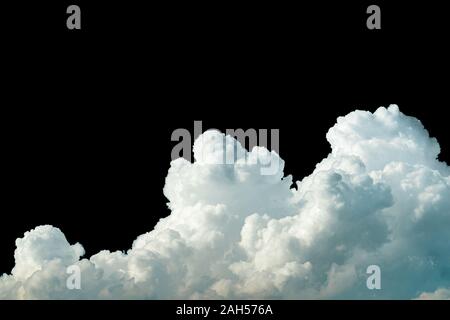 Pure white cumulus clouds on black background. Cloudscape background. White fluffy clouds on dark background. Soft cotton feel of white clouds texture Stock Photo