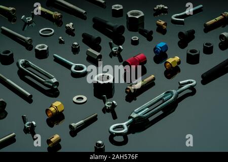 Metal bolts, nuts, and washers. Fasteners equipment. Hardware tools. Different types of nuts, bolts, and screws on table in workshop. Mechanic tools. Stock Photo