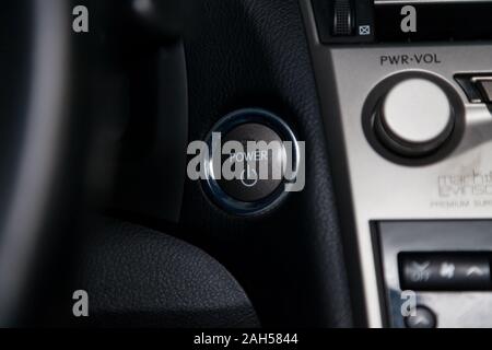 Novosibirsk, Russia - 12.19.2019: Button start and turn off the ignition of the car engine close-up on the dashboard, electric key, of modern design b Stock Photo
