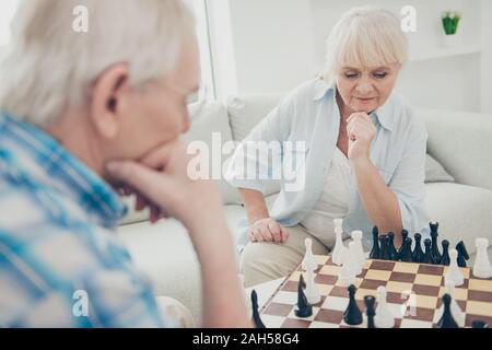 Portrait of his he her she two nice attractive focused concentrated, intelligent people creating new move win winner amateur championship in light whi Stock Photo