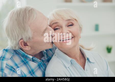 Close-up portrait of her she his he two nice attractive lovely affectionate, sweet gentle cheerful cheery life partners soulmates cuddling kissing in Stock Photo