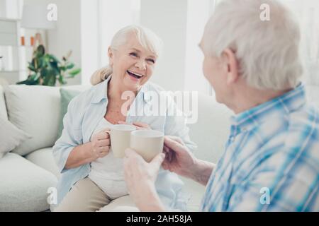 Portrait of her she his he two nice attractive cheerful cheery glad positive spouses, discussing news having fun morning spending time joking in light Stock Photo