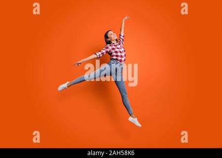 Full size body length photo of pretty glad attractive light gorgeous, lady jumping up showing graceful movements isolated bright color background Stock Photo