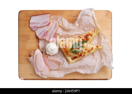 Thin pancakes stuffed with ham and bacon isolated on white Stock Photo