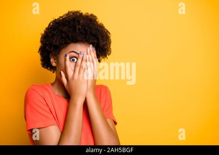 Copyspace photo of scared terrified casual lady covering her face with hands, not to see terrifying things she is afraid of while isolated over vibran Stock Photo