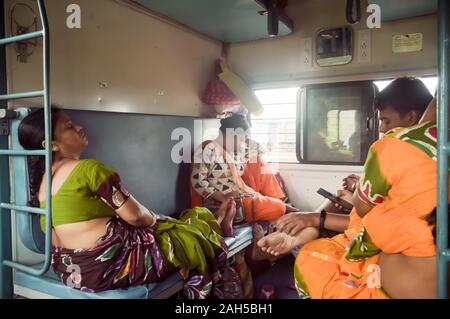 Patna India May 2019 - Tired exhausted woman Passengers falling asleep in a long ride, sitting in their seat and taking a nap inside a train compartme Stock Photo
