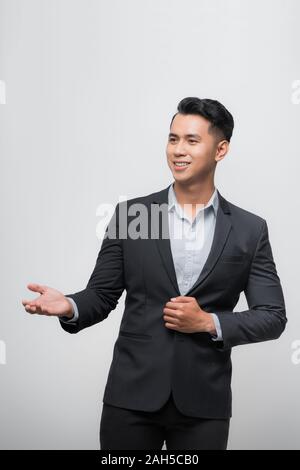 Happy Asian boss manager business man wears black suit in relax pose. Stock Photo