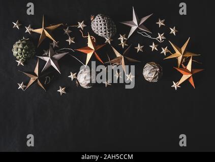 Holiday toy decorative stars, cones and balls over black background Stock Photo