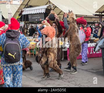 Sibiu, Romania - December 21, 2019. Romanian christmas traditional customs called Bear dancing, on Christmas Eve, in the Cibin vegetable market from S Stock Photo