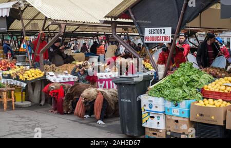 Sibiu, Romania - December 21, 2019. Romanian christmas traditional customs called Bear dancing, on Christmas Eve, in the Cibin vegetable market from S Stock Photo