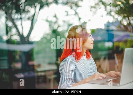 Portrait Young Asian woman working with computer. Modern freelance job lifestyle concept.  Stock Photo