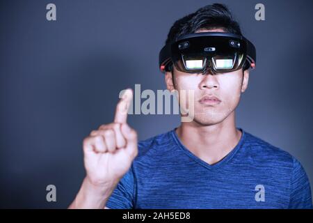 Experience VR hololens headset in studio with advanced technology. Body gesture when using virtual reality glasses Stock Photo