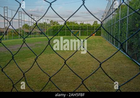 Fenced soccer fiels or handball field with lights Stock Photo