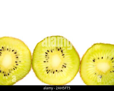 Kiwi slices in a row on white background Stock Photo