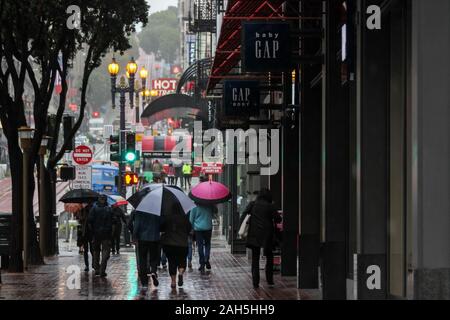 People with umbrellas on Powell Street on a rainy day in San Francisco, United States of America Stock Photo