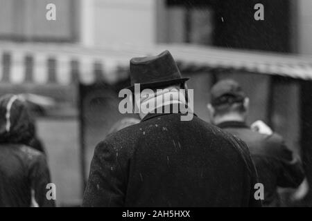 Middle-aged man with hefty neck and trilby hat on a rainy day Stock Photo