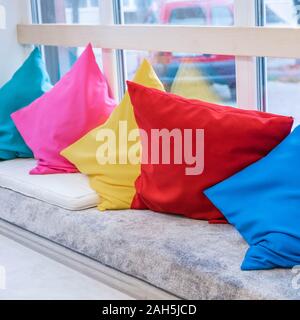 Cozy design of the sofa with pillows of different colors. Rainbow colors Stock Photo