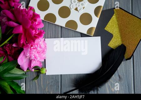 Background with peonies. Pink and burgundy peonies on a wooden background with space for copywriting. Frame for text with flowers. Greeting card with Stock Photo