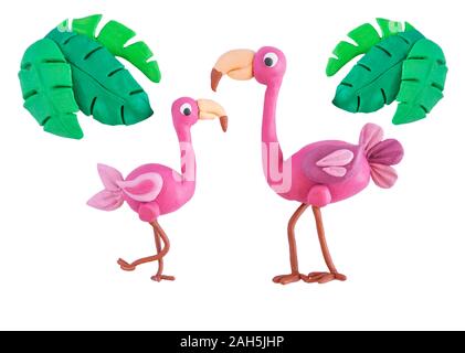 Pink flamingo with palm leaves made of plasticine isolated on white background. Crafts from platinum. Plasticine bird flamingo Stock Photo