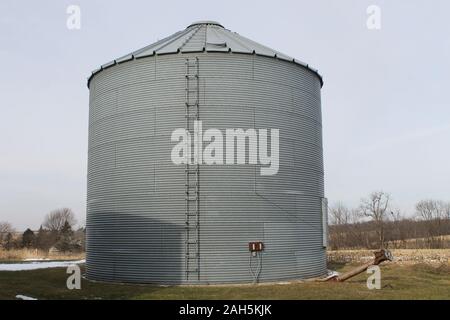 Grain bin located on an Iowa farm in the Midwest Stock Photo