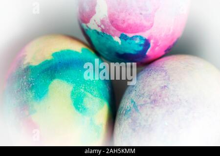 Brightly colored Easter eggs background in a small bowl for the holiday. Stock Photo