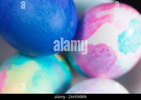 Brightly colored Easter eggs background in a small bowl for the holiday.