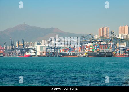 HongKong, China - November 2019: Freight container ship and cranes at  harbour logistics centre / port in Hong Kong Stock Photo