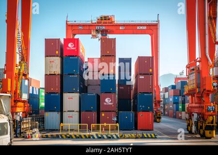 HongKong, China - November 2019: Stacked shipping container on freight harbour logistics centre in Hong Kong Stock Photo