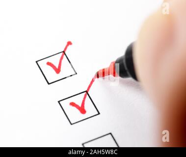 Red tick marking on checklist Stock Photo - Alamy