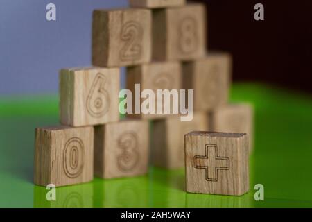 Arithmetic, mathematic, learning concept, numbers background with wooden cubes. Shallow Depth of Field Stock Photo