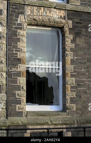 Aberystwyth Ceredigion Wales, UK December 25 2019: Broken glass window pane on a disused office building the old County Offices, Marine Terrace Stock Photo