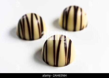 Three white chocolate candies isolated on a white background. Stock Photo