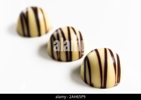 Three white chocolate candies isolated on a white background. Stock Photo
