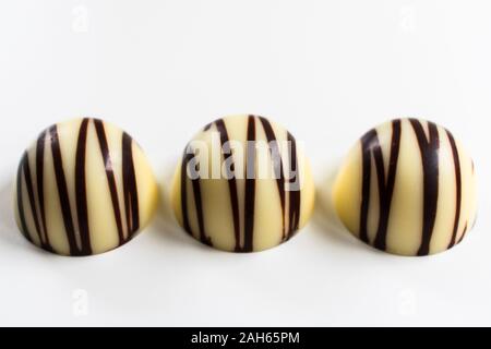 Three white chocolate candies isolated on a white background. Stock Photo