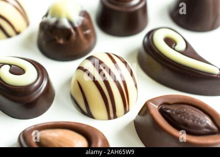 Background of different chocolates on a white background. Flat lay Stock Photo