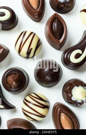 Background of different chocolates on a white background. Flat lay Stock Photo