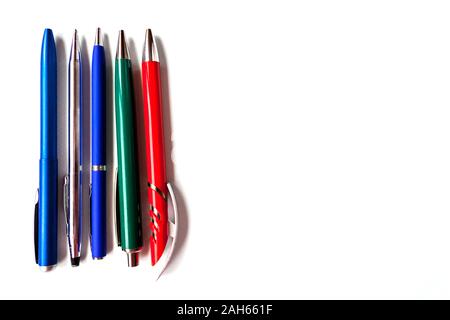 row selection of assorted multi colored ballpoint pens of different colors on light blue background. Back to school creativity concept. Selective focu Stock Photo