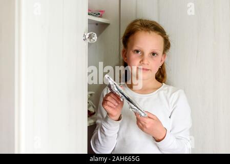 Girl Found it. Afikoman is a half-piece of matzo which is broken of the Passover Seder.In many families the father takes the afikoman and hides it.The child that finds the afikoman receives gift. Stock Photo