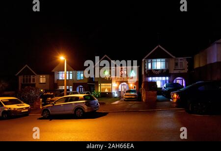 Poole, UK. 25th December 2019: Residential houses in Poole are lit up for Christmas on Runton Road. Home owners invite onlookers with optional charity donations. Credit: Thomas Faull/Alamy Live News Stock Photo