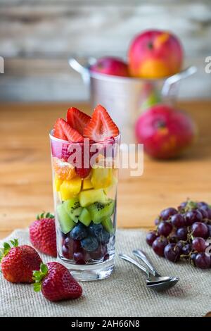 Rainbow fruit salad in glass.