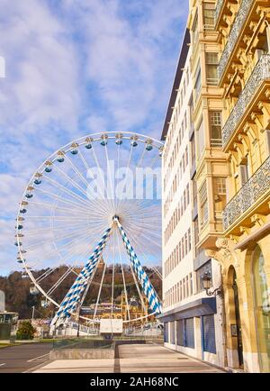 A Ferris wheel in the city of San Sebastian. View from Miramar street. Basque Country, Spain. Stock Photo