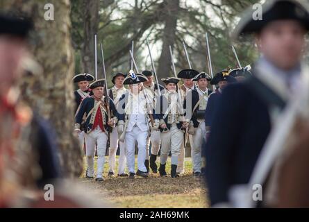 Washington Crossing, Pennsylvania, USA. 25th Dec, 2019. Soldiers march past a barn as they ready to go to their boats during the official Christmas Day Crossing of the Delaware reenactment by George Washington and his troops  Wednesday, December 25, 2019 at Washington Crossing State Park in Washington Crossing, Pennsylvania. (WILLIAM THOMAS CAIN / PHOTOJOURNALIST) Credit: William Thomas Cain/Alamy Live News Stock Photo