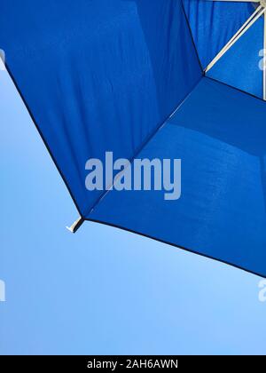 Umbrella against blue clear sky, summer at the beach Stock Photo